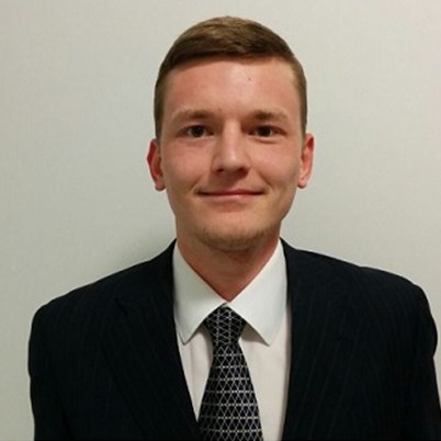 Profile of grad Nail in a suit